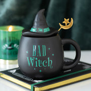 Bad Witch black ceramic mug with witch hat lid and gold crescent moon spoon.