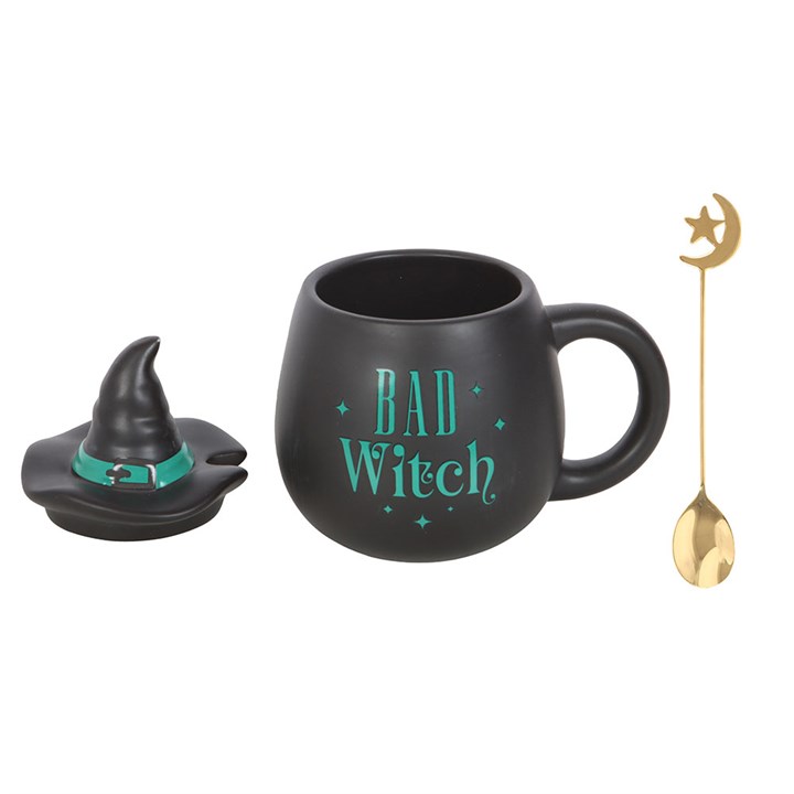 Bad Witch mug with lid removed beside gold crescent moon spoon.