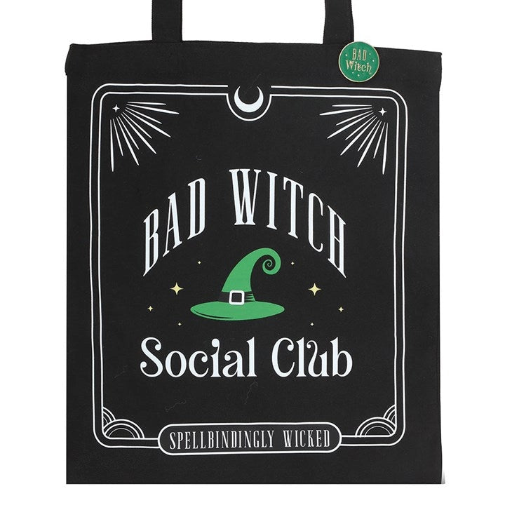 Close-up of tote bag design with green witch hat and bold typography.