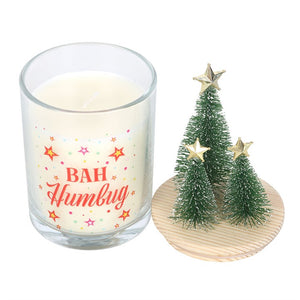 Bah Humbug Orange & Clove candle with removable wooden lid topped with Christmas tree decorations, showing printed festive glass jar separately.