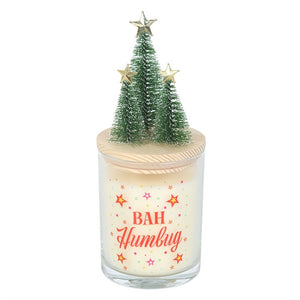 Bah Humbug Orange & Clove Christmas candle with star-topped mini Christmas trees on wooden lid and bold festive print on glass jar.