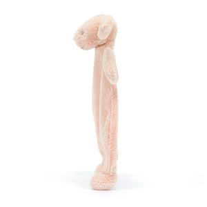 Cozy side view of Jellycat Bashful Blush Bunny Comforter. Soft pink bunny comforter with unstuffed tummy for snuggles. Perfect for comforting little ones