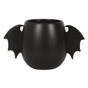 Front-facing view of rounded black ceramic mug with bat wing-shaped handles – spooky Halloween-themed drinkware
