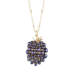 Closed view of Bill Skinner Blackberry & Mouse Necklace showing gold-plated locket encrusted with clustered purple synthetic pearls.
