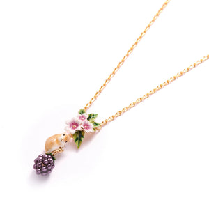 Close-up of Bill Skinner Blackberry & Mouse Necklace featuring a gold-plated chain with enamel pink flowers, a detailed mouse figurine, and a glossy purple blackberry charm.
