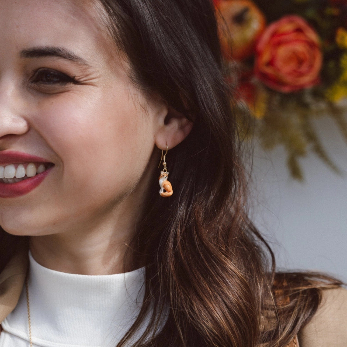 Woman wearing Bill Skinner Fox Drop Earrings from the Woodland Tales collection, showing detailed hand-painted red fox design in gold-plated finish.
