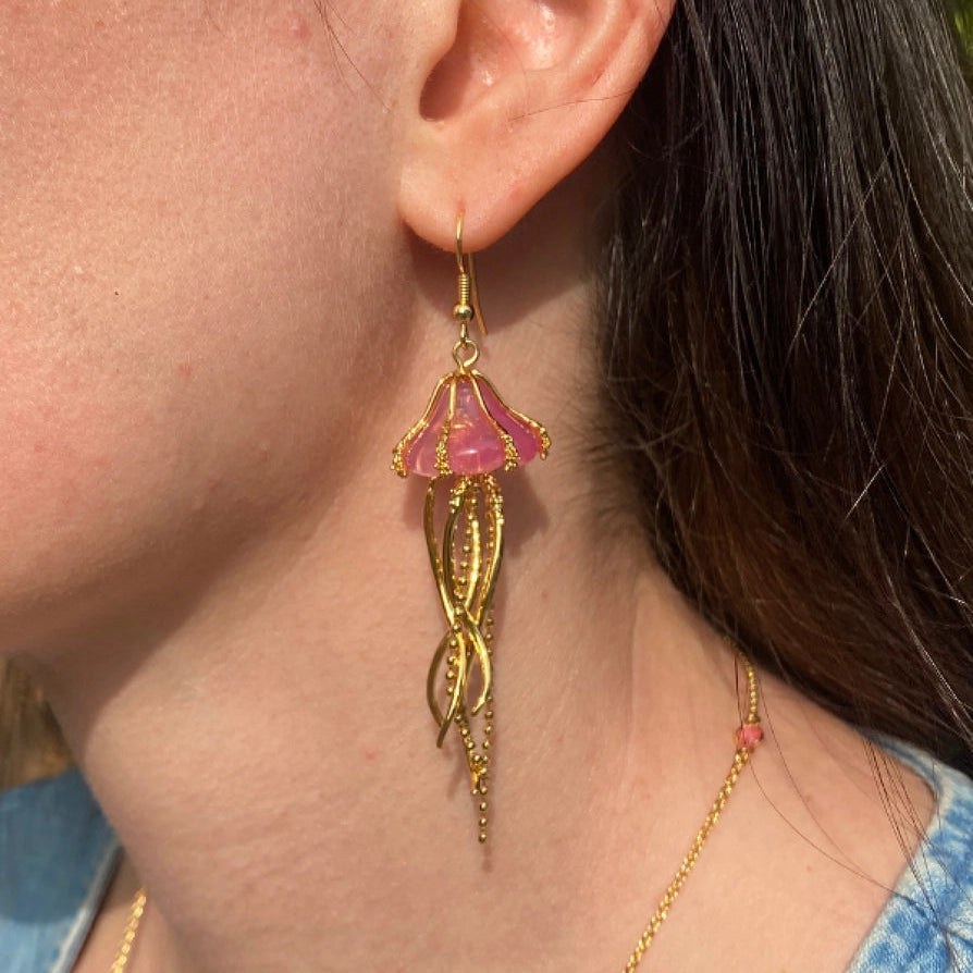Model wearing Jellyfish Drop Earrings, showing elegant gold-plated design.