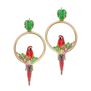 Pair of Bill Skinner parrot front-facing earrings with red enamel parrots, tropical foliage, and gold hoops set against a white background.