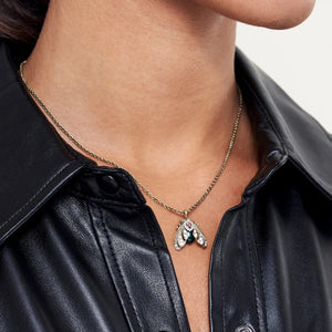 Model wearing Tahitian Pearl Moth Necklace with black leather shirt.