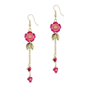 Pink and gold wildflower drop earrings with enamel flowers, gold-plated chain, and leaf accents by Bill Skinner.