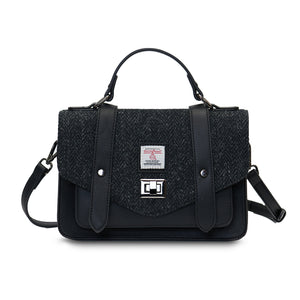 Black Herringbone Medium Satchel with Harris Tweed® shown from the front with top handle and detachable shoulder strap.