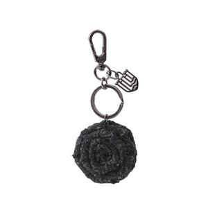 A sleek black herringbone Harris Tweed rose keyring, providing a minimalist and modern aesthetic.