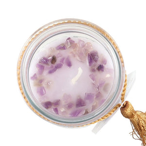 Top-down view of amethyst crystals embedded in the wax of the Blackberry Tube Candle.