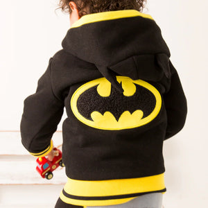 Back view of toddler in Batman “Get Ready” Hoodie showing large textured yellow and black bat emblem across the back.