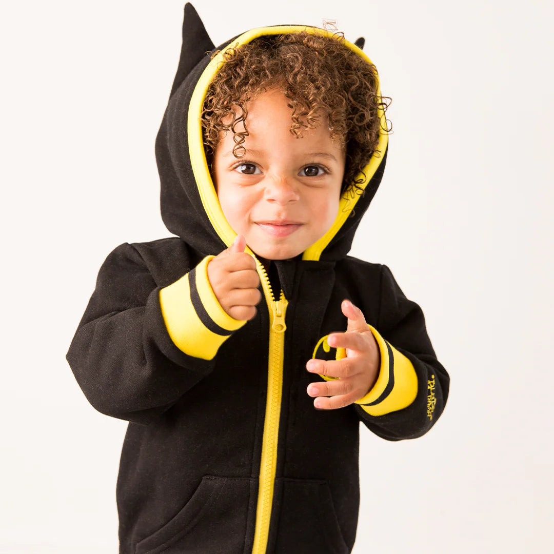 Smiling toddler wearing hood-up Batman “Get Ready” Hoodie with bat ears and bold yellow trim.