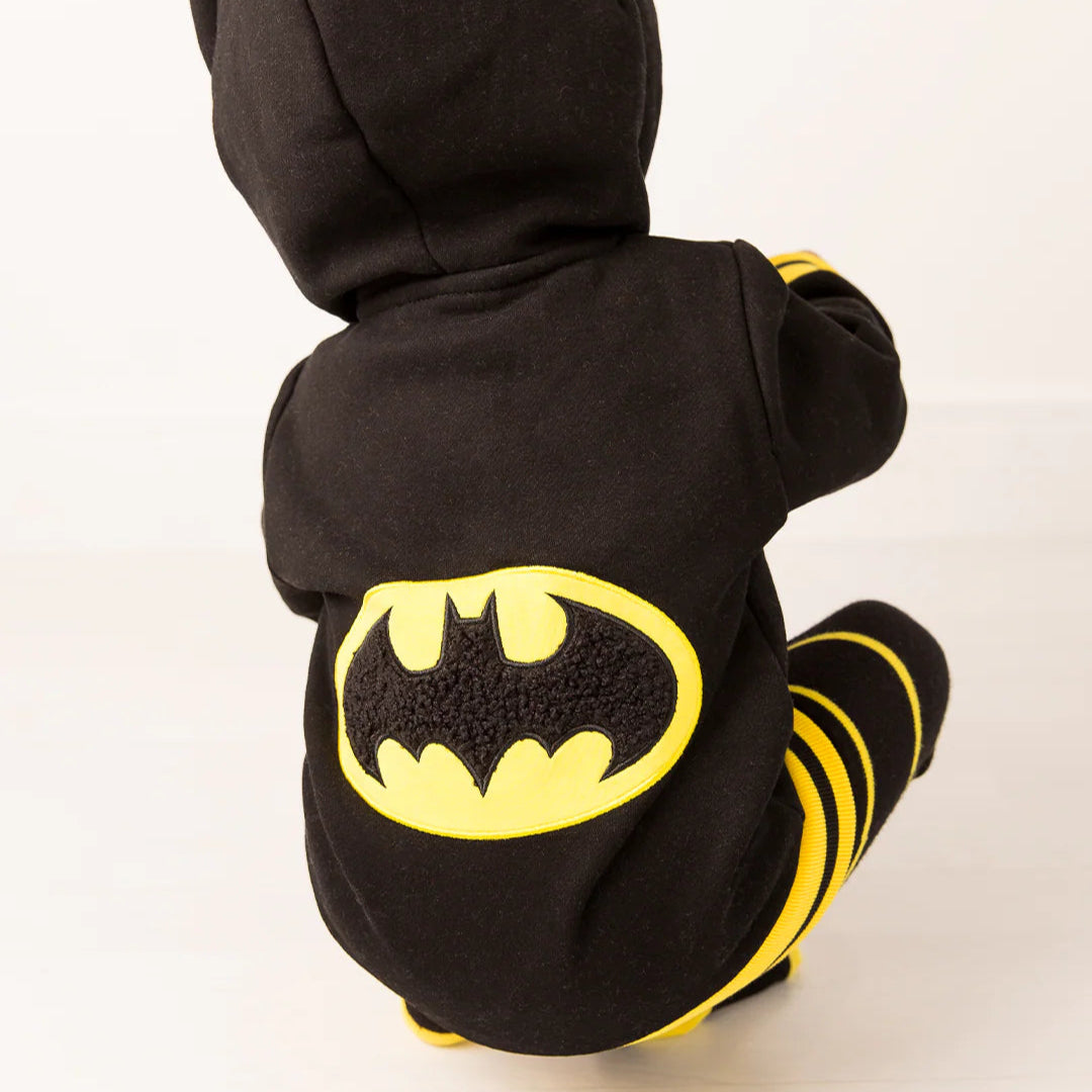 Rear view of child crouching in Batman “Get Ready” Hoodie with prominent yellow bat symbol on back and matching striped leggings.