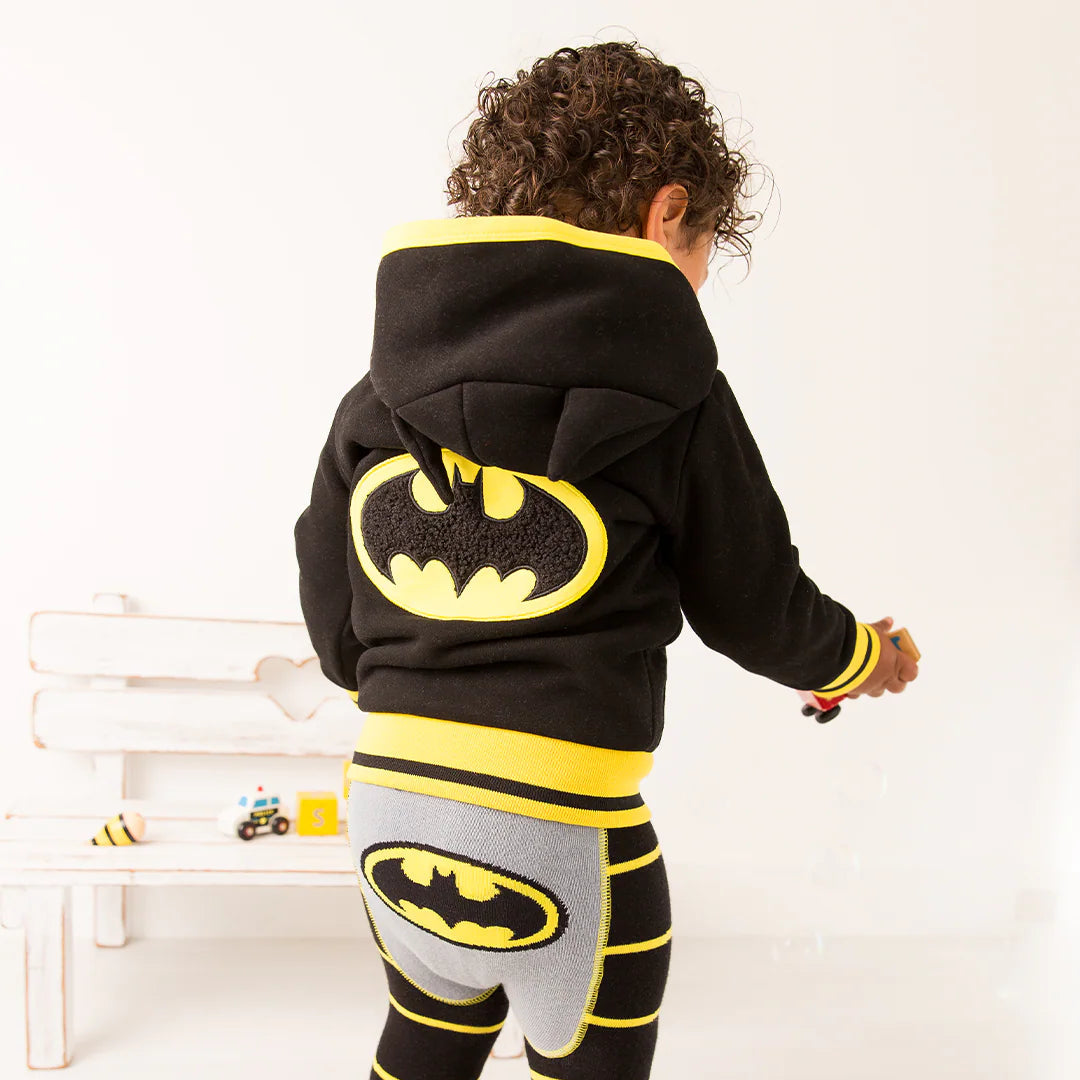 Back view of child standing in Batman “Get Ready” Hoodie with large yellow bat emblem and matching leggings with bat logo on bottom.