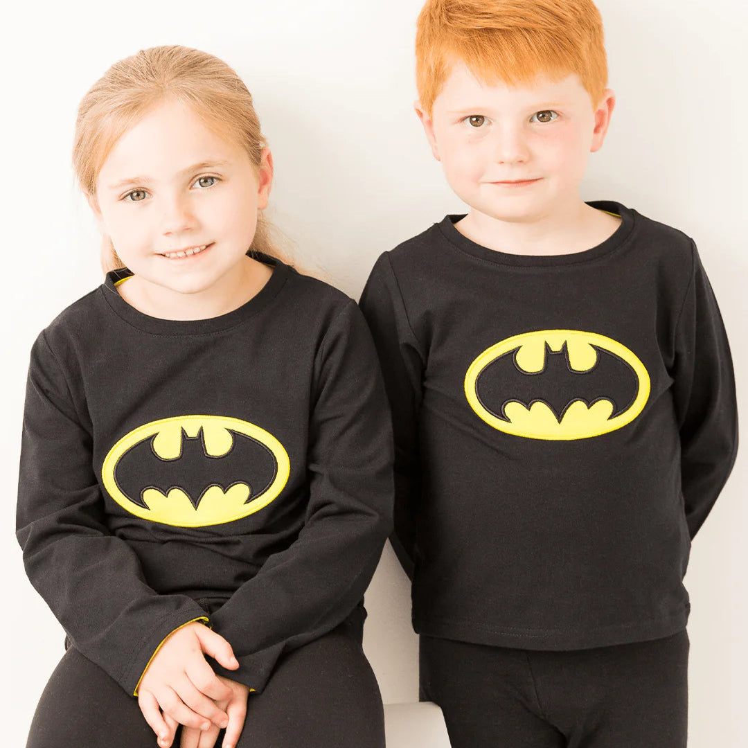 Two children wearing matching Batman™ “Get Ready” Tops in black and yellow.