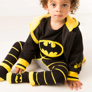 Toddler sitting in Batman™ “Get Ready” Top with matching leggings and socks.