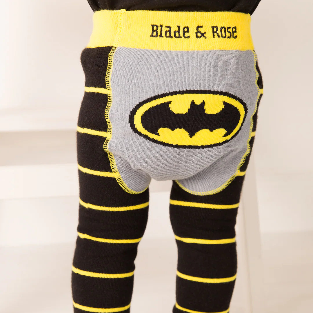 Rear view of toddler wearing Blade & Rose Batman™ leggings featuring iconic yellow Bat-signal motif on grey bum panel with striped black and yellow legs.