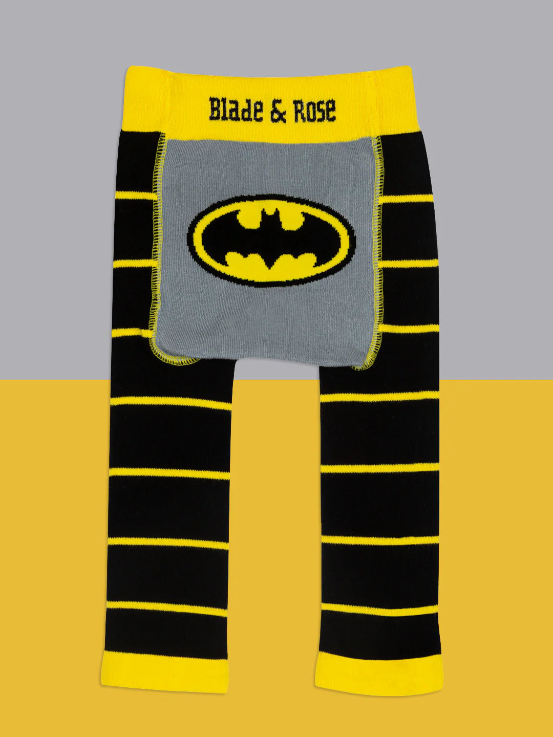 Flat lay of Blade & Rose Batman™ “Get Ready” leggings in black and yellow stripes with grey seat panel featuring bold yellow Bat-signal.