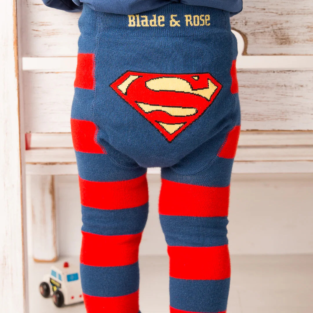 Toddler standing in Blade & Rose Superman™ leggings, navy and red striped legs with iconic Superman™ shield design on the back.