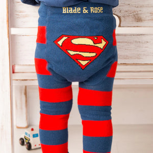 Toddler standing in Blade & Rose Superman™ leggings, navy and red striped legs with iconic Superman™ shield design on the back.