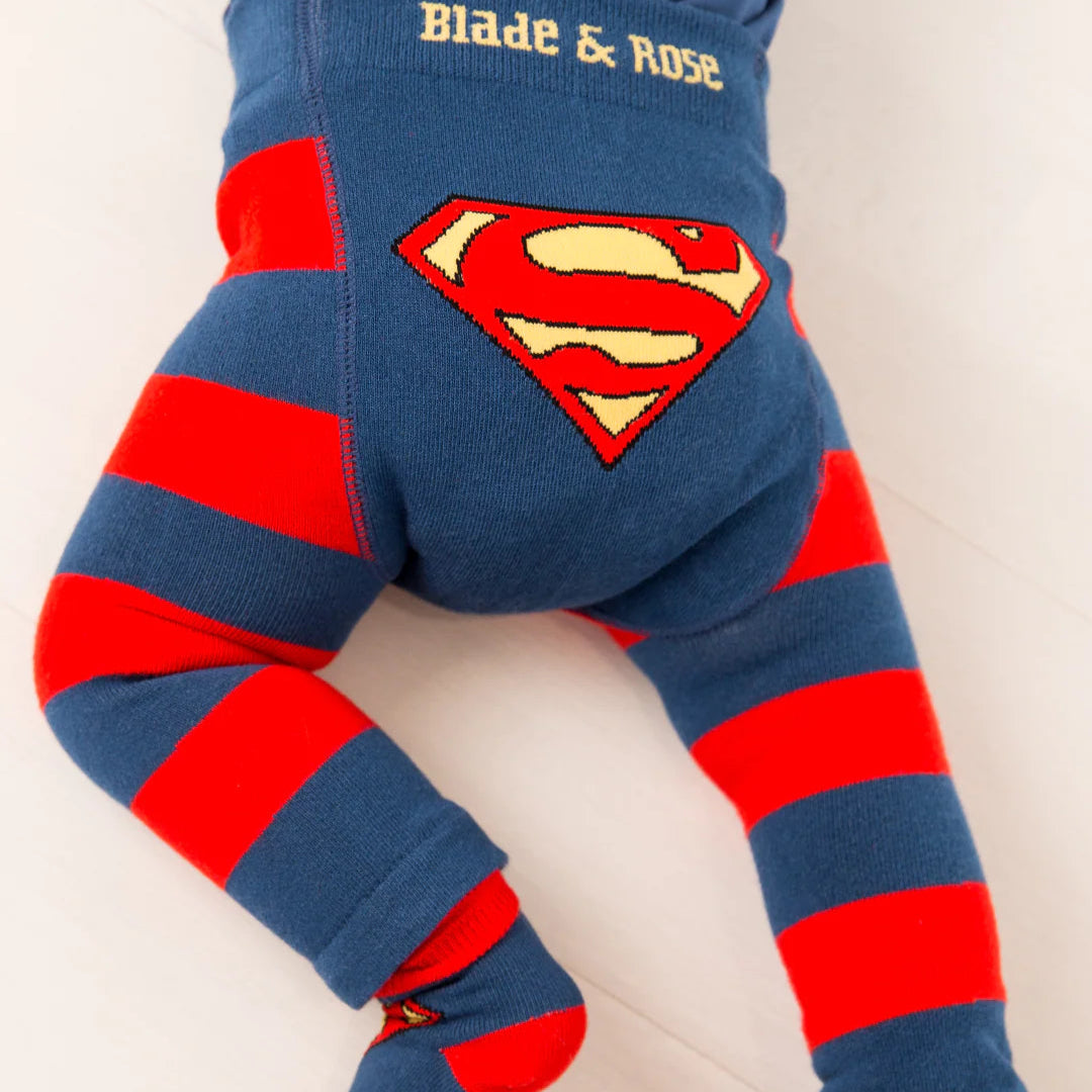 Baby crawling in Blade & Rose Superman™ Saves the Day leggings, close-up of red and yellow Superman™ shield and colourful striped pattern.