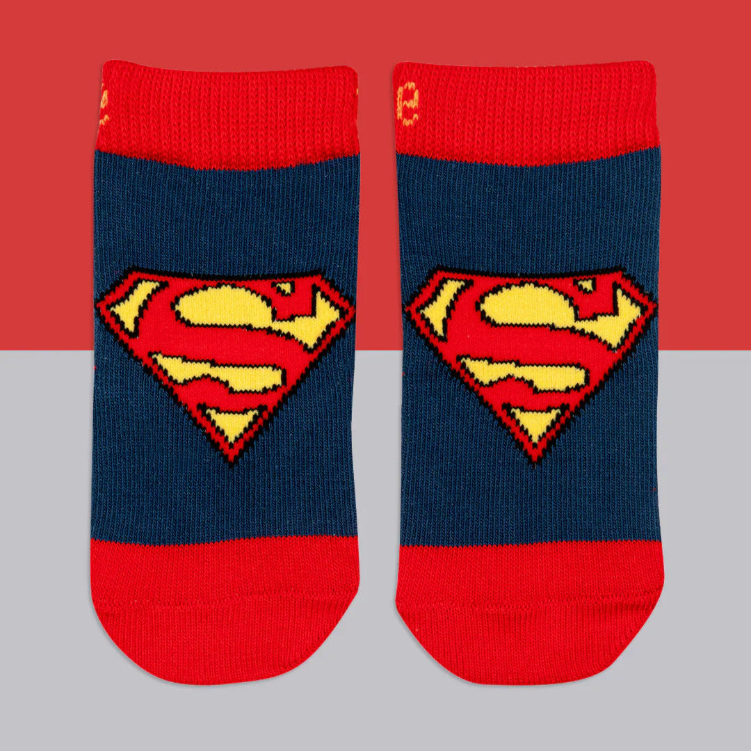 Superman™ “Saves the Day” baby socks in blue and red with iconic Superman shield emblem, flat lay view.