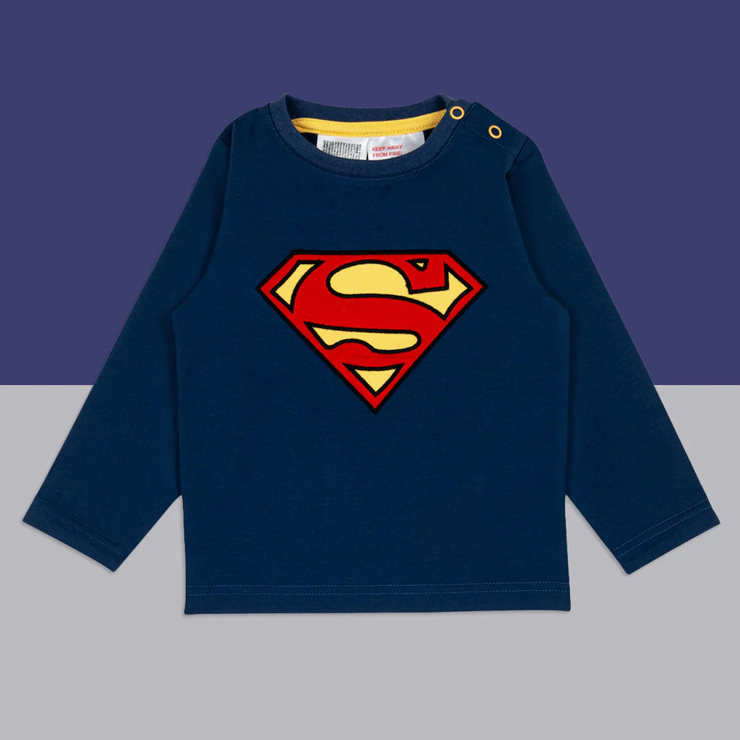 Flat lay of Superman™ blue long-sleeved top with applique logo, on navy and grey background.