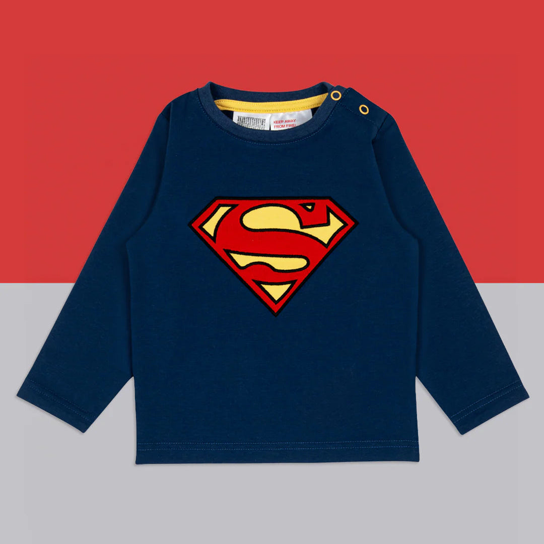 Flat lay of Superman™ blue long-sleeved top with applique logo, on navy and grey background.