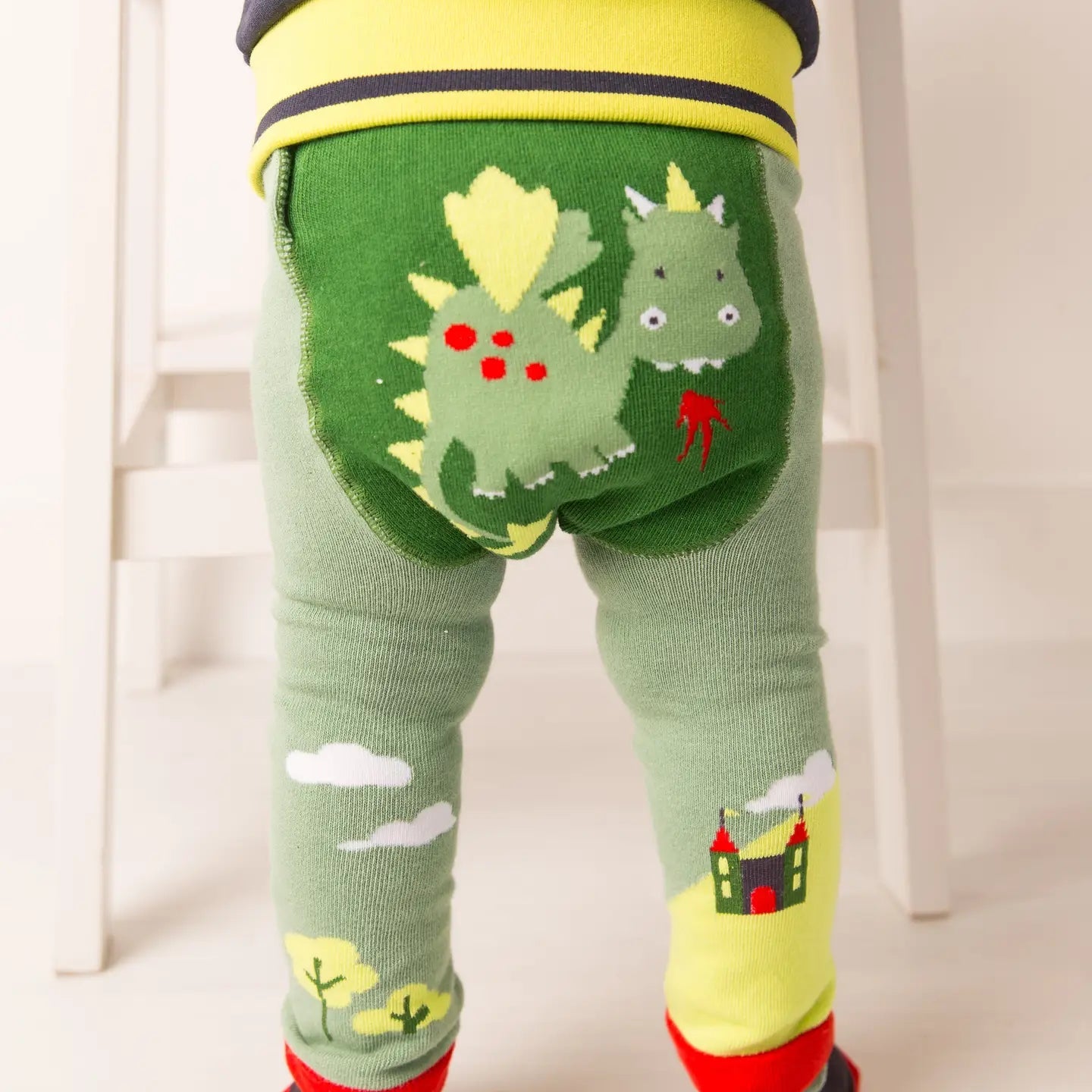 Toddler wearing Blade & Rose Teddy the Dragon leggings with dragon character on the bottom.
