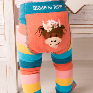 Close-up of Blade & Rose Bonnie Highland Cow leggings featuring a floral-adorned Highland cow on the bottom.