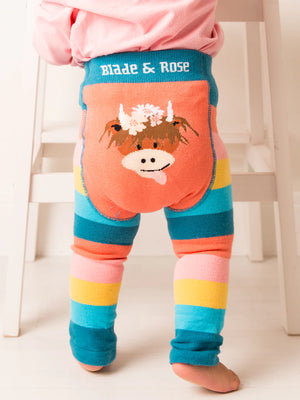 Child playing while wearing Blade & Rose Bonnie Highland Cow leggings with a matching pink top.