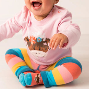 Toddler wearing Bonnie Highland Cow leggings with vibrant rainbow stripes and an adorable Highland cow print.