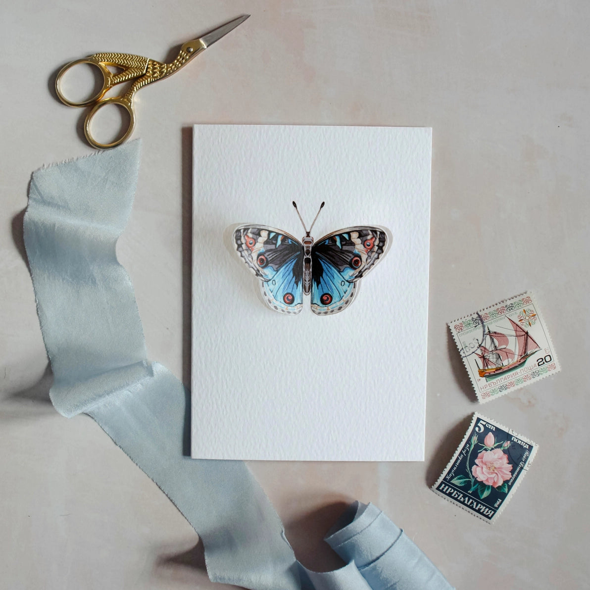 Blue Pansy Butterfly Pop Out Card with envelope, flat lay.