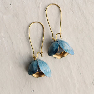 Close-up of Bluebell Earrings on a white background – A pair of handcrafted bluebell earrings featuring vintage glass beads and layered brass petals with a painted blue finish.