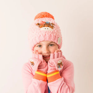 Girl wearing Bonnie Highland Cow Winter Hat and gloves – cute winter kids set with cow motif.