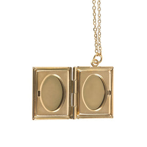 Interior view of open gold book locket with space for two small photos.