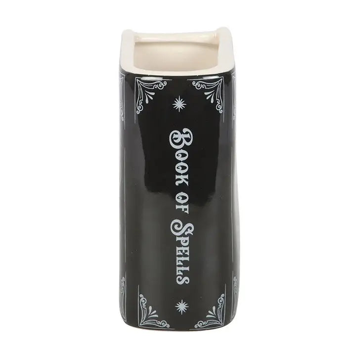 Side profile of gothic ceramic vase with ‘Book of Spells’ printed on spine, styled like an open book.