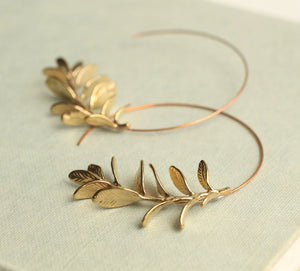 Close-up of Botanical Leaf Hoop Earrings in Gold, featuring intricate rosemary leaf details on brass hoops.