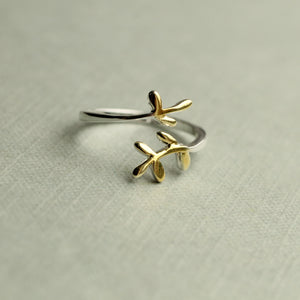 Angled view of the silver sprig ring on a neutral background.