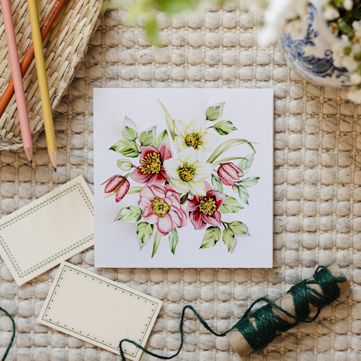 Front view of Bouquet Pop Out Floral Greetings Card with 3D hellebore flowers on textured cream background.