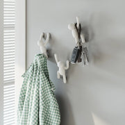 Umbra Buddy wall hooks set of three in white mounted on wall with items