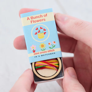 Bunch of Flowers Mini Cross Stitch Kit in a Matchbox with colourful threads inside.