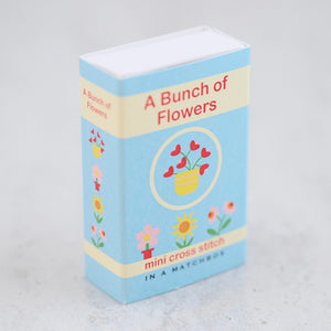 Side view of the Bunch of Flowers Mini Cross Stitch Kit in a Matchbox.