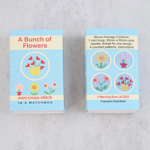 Back view of the matchbox showing four possible floral cross stitch designs.