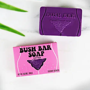 Bush Bar Soap purple coconut-scented body positive soap bar with matching pink packaging, photographed on a white background.