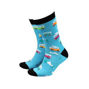 Bright blue men’s bamboo socks with multicoloured camper van pattern, black heel and toe, displayed standing up to show design.