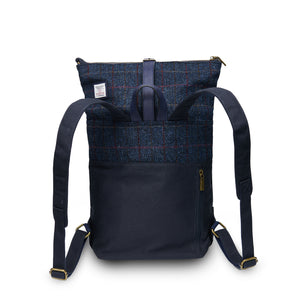 Behind: Navy Over Check Tartan Canvas Backpack with Harris Tweed® (back view) with adjustable straps. Showcasing the large size of the backpack.